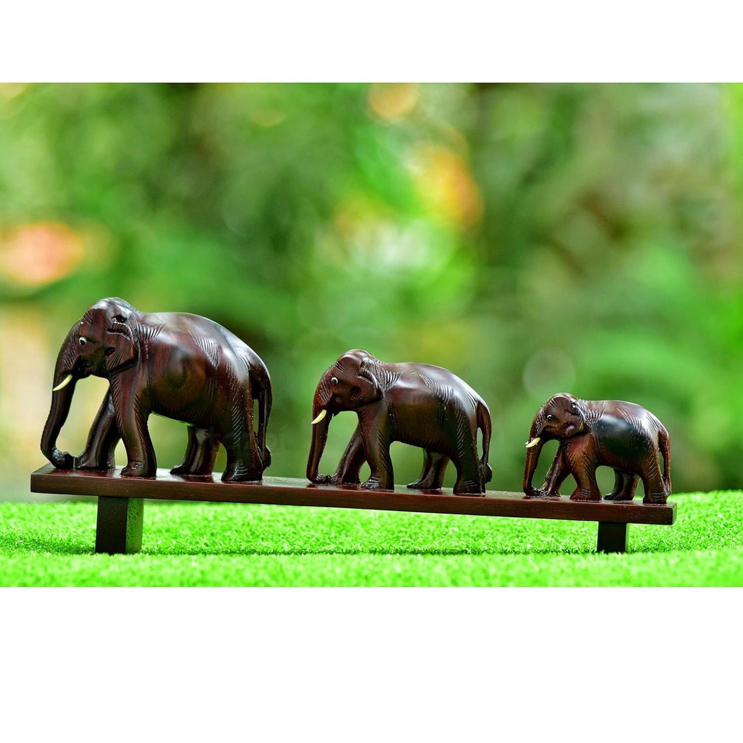 Handcrafted rosewood model of three elephants crossing a bridge ideal for home décor and gifting