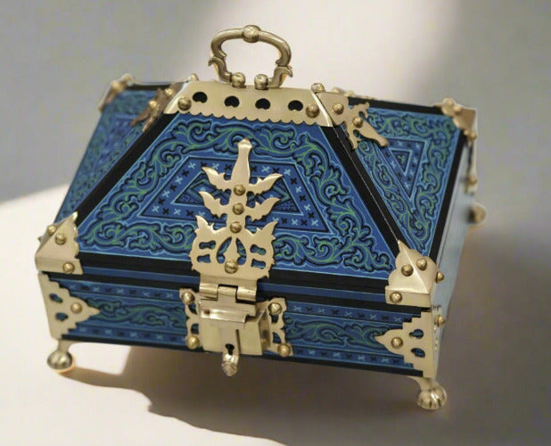 Decorative blue and gold box on a marble surface
