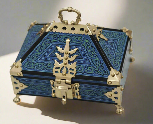 Decorative blue and gold box on a marble surface